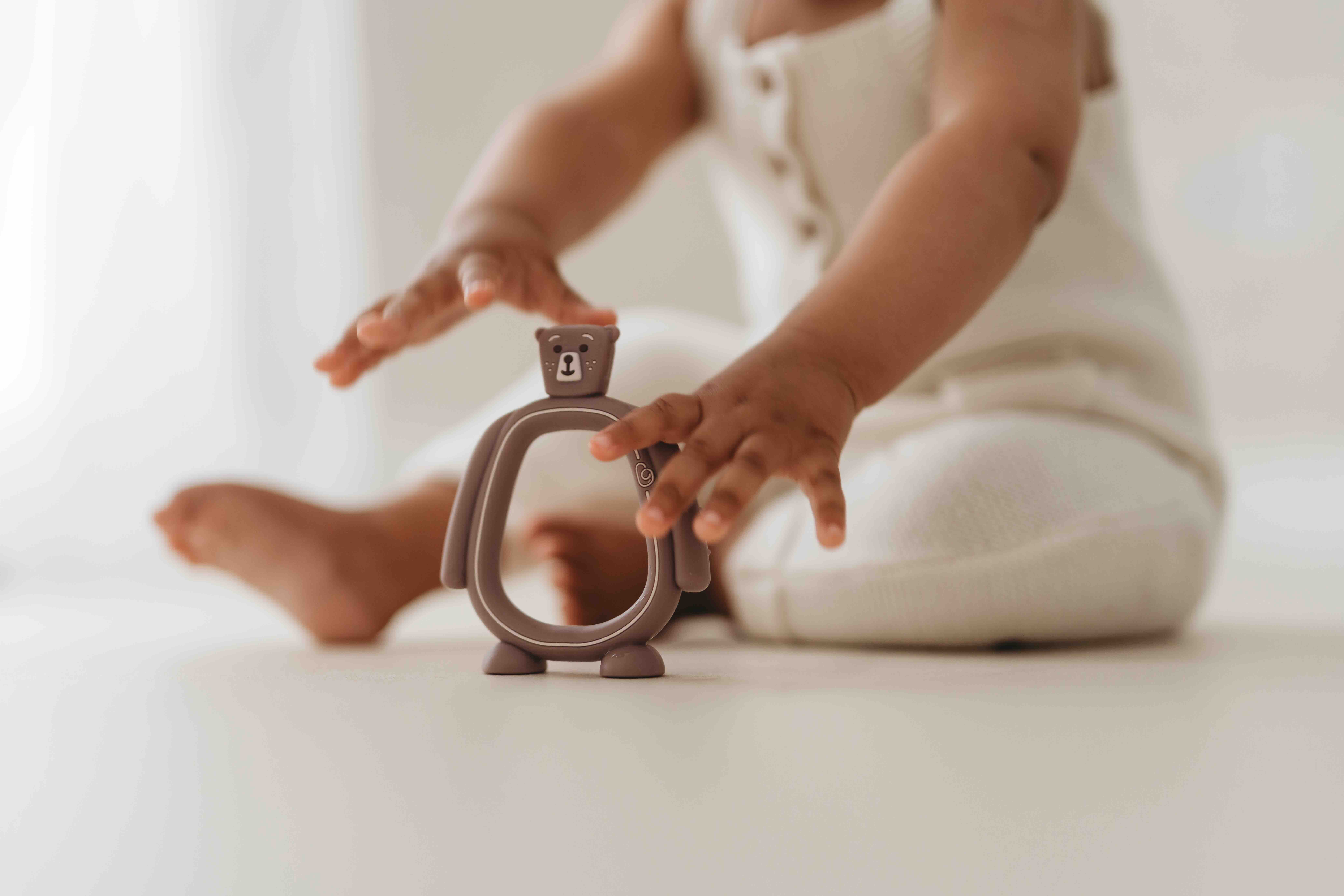 Baby pointing at the Bear Buddy teether