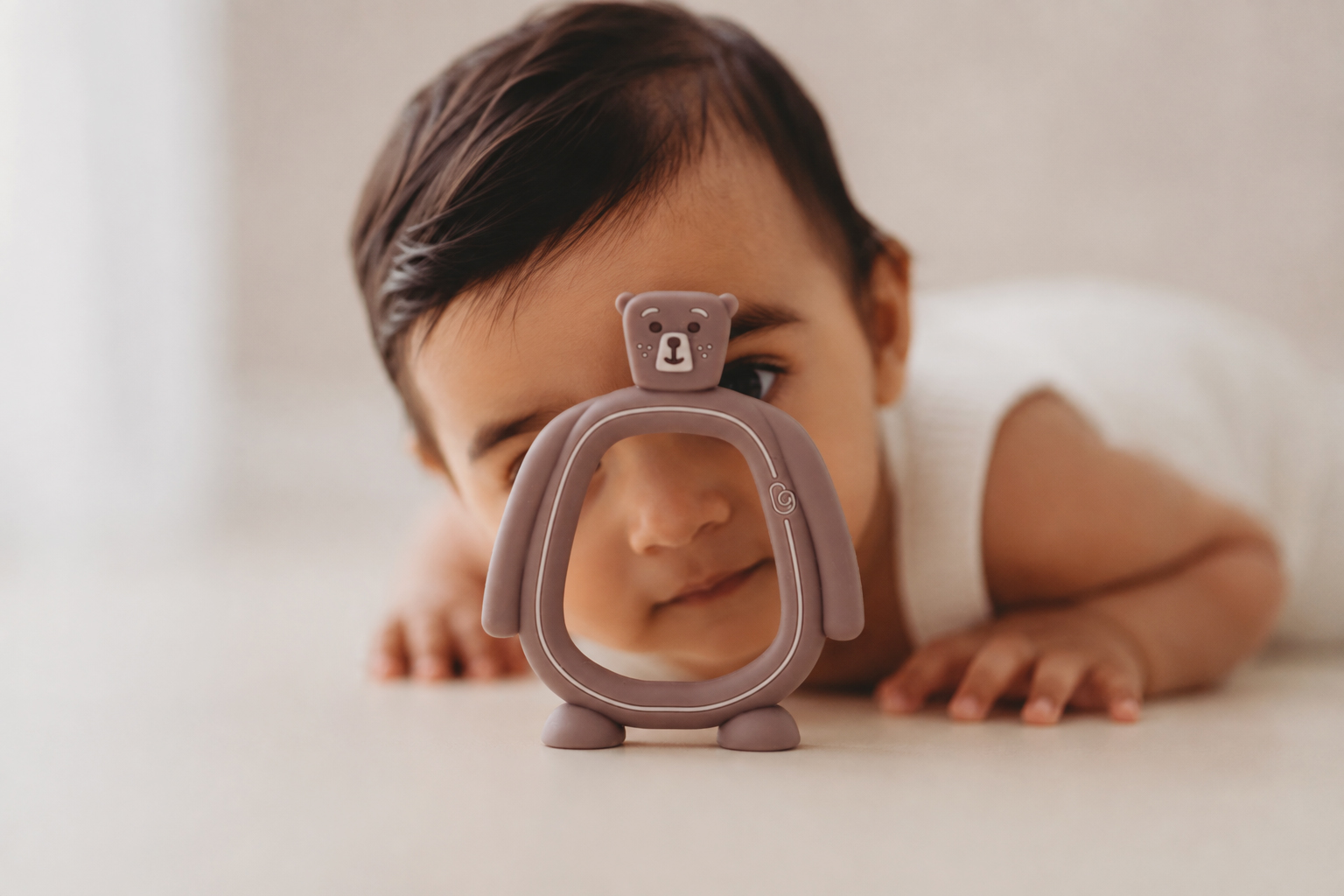 Baby on their tummy with the Bear Buddy teether
